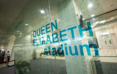 A glass printed 'Queen Elizabeth Stadium' in Distrubution Exchange Lobby